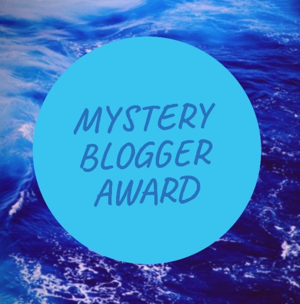 Mystery Blogger Award Logo. Mauve all-capitals text in the centre of a turquoise circle, with an ocean background.
